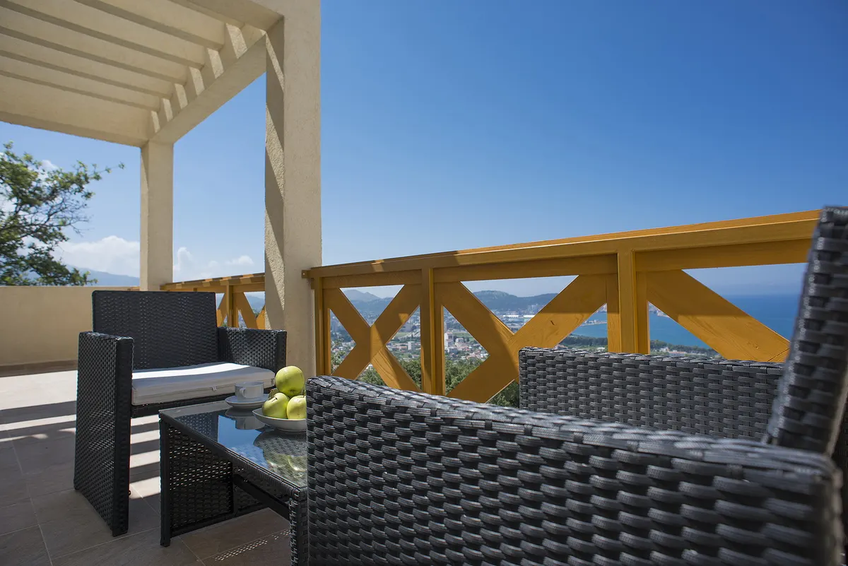 Covered terrace with outdoor seating and a sea view